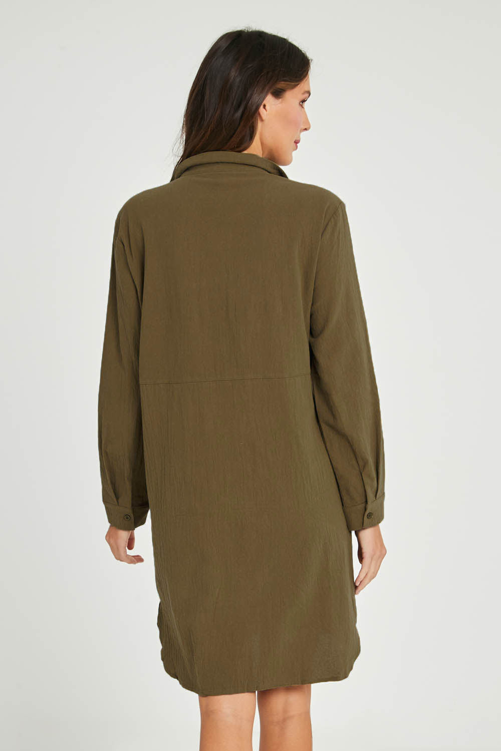 Model Madeline wearing size 10 of the Splice Print Tunic Shirt in colour Khaki (Green), from the back