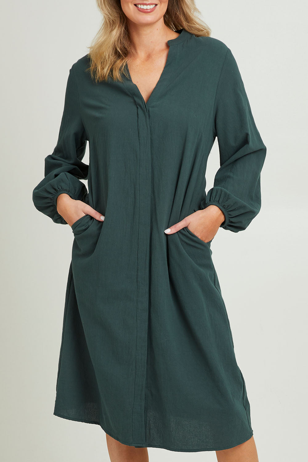 Model Grace wearing size 10 of the Upcycle Midi Shirt Dress in colour Forest (Green), from the front, cropped image