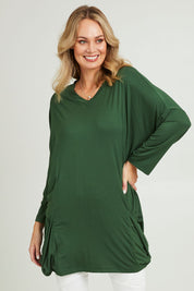 Model Grace wearing size 10 of the Modal Knit L/S Top in colour Green (Green), from the front, cropped image