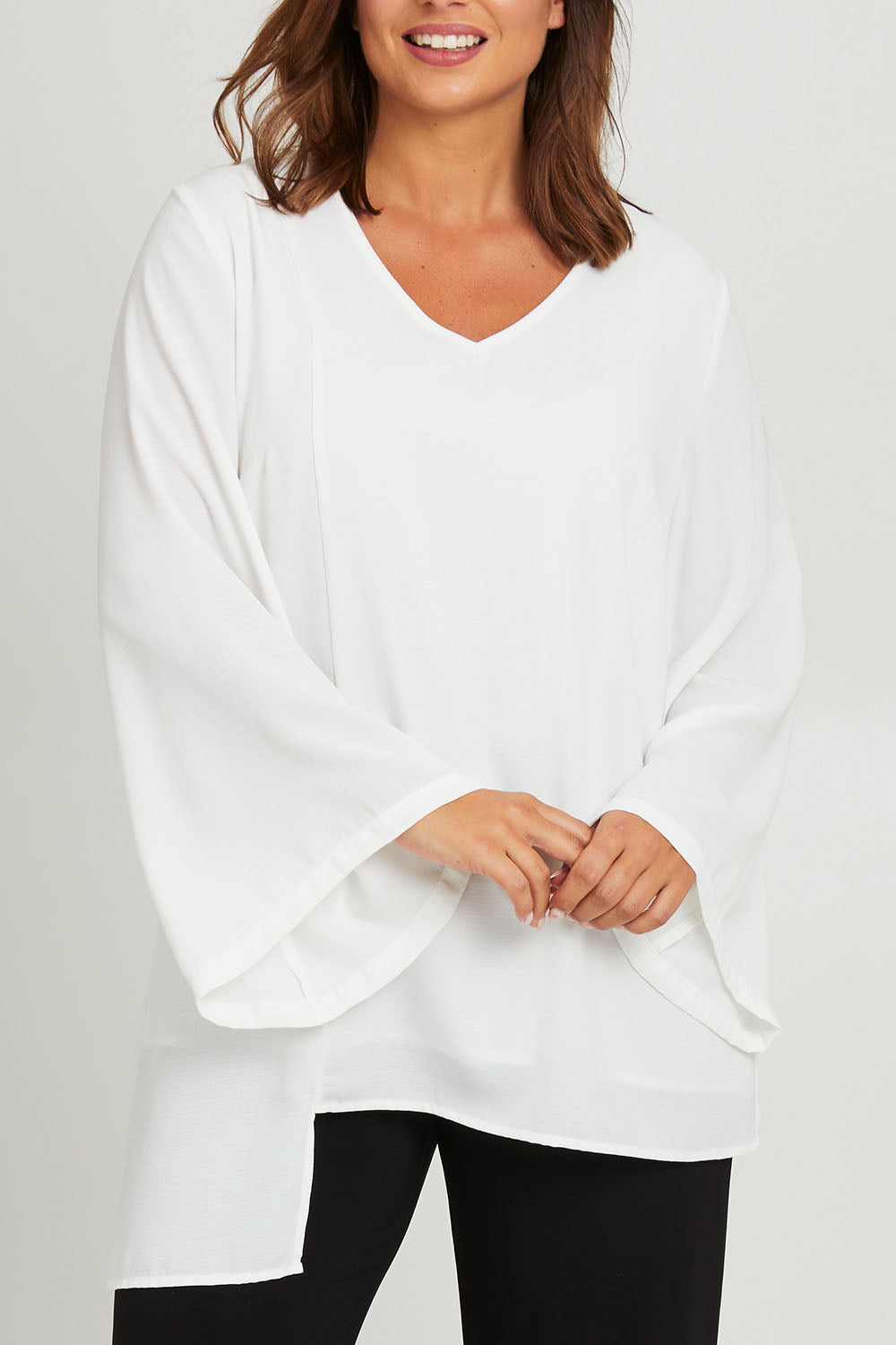 Model Monique wearing size 14 of the Overlay Top in colour White (White), from the front, cropped image
