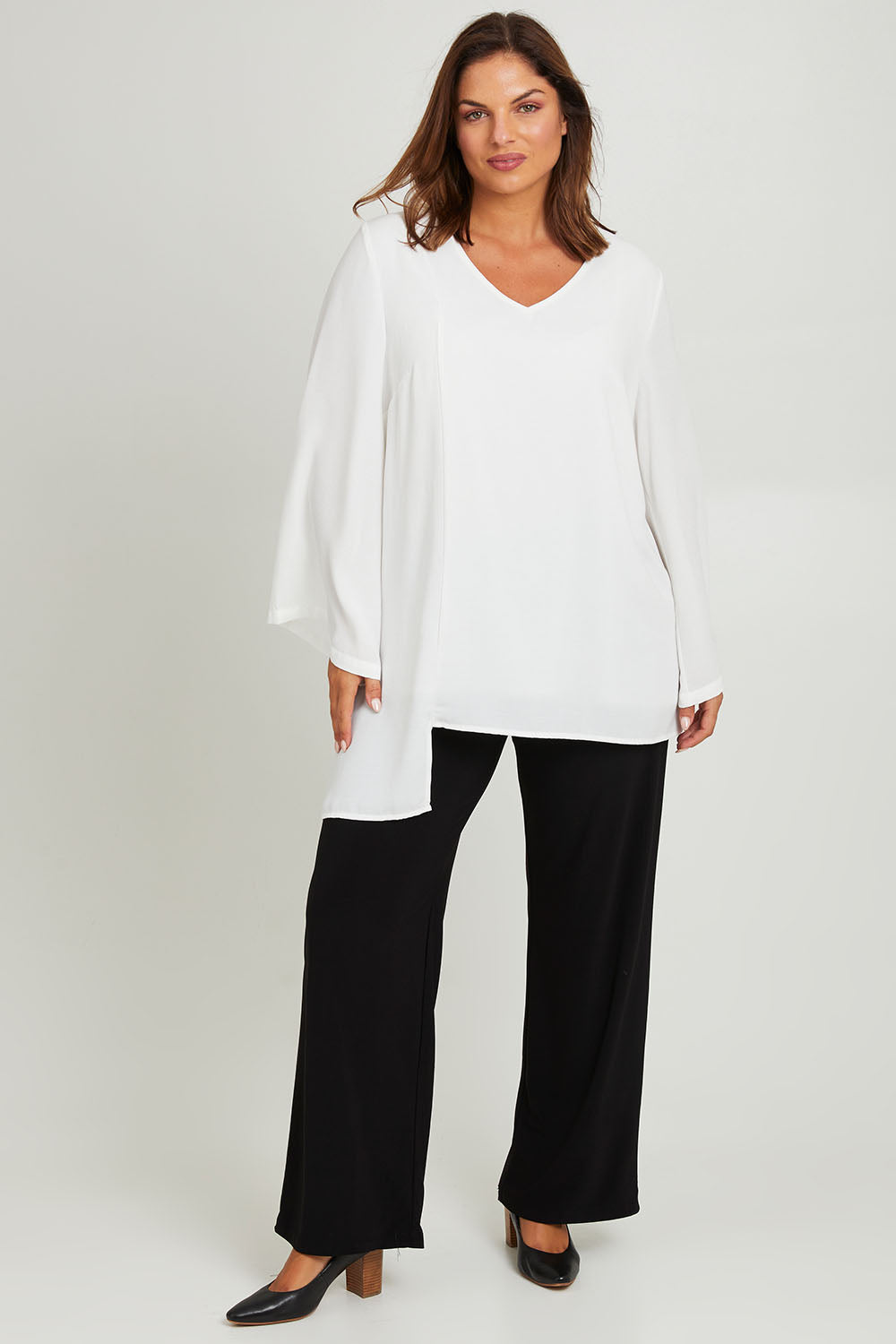 Model Monique wearing size 14 of the Overlay Top in colour White (White), from the front, showing the whole outfit