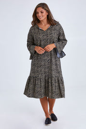 Model Monique wearing size 14 of the Elegantly Waisted Dress in colour Elegantly, from the front, showing the whole outfit
