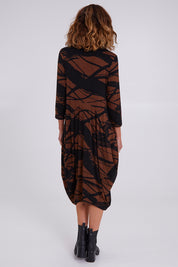 Model Emma wearing size 10 of the Bounce Dress in colour Mocha, from the back