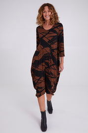 Model Emma wearing size 10 of the Bounce Dress in colour Mocha, from the front, showing the whole outfit