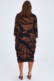 Model Monique wearing size 14 of the Bounce Dress in colour Mocha, from the back