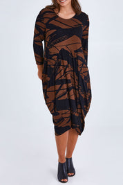Model Monique wearing size 14 of the Bounce Dress in colour Mocha, from the front, cropped image