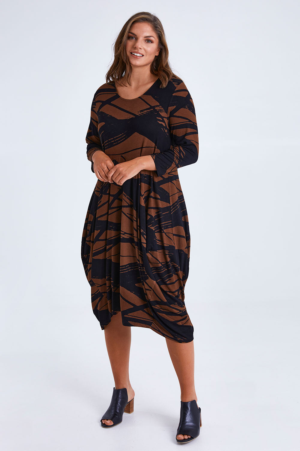 Model Monique wearing size 14 of the Bounce Dress in colour Mocha, from the front, showing the whole outfit