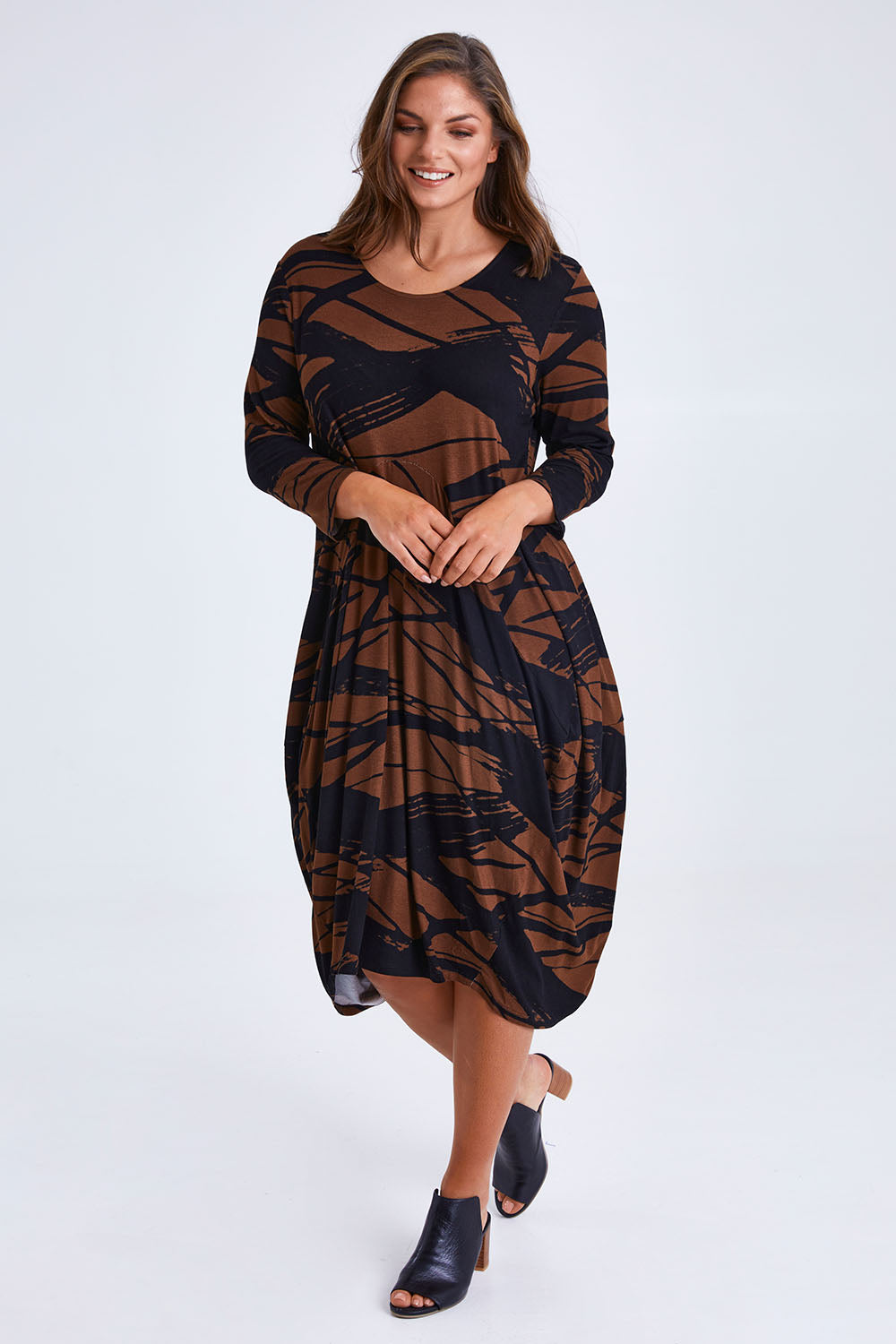 Model Monique wearing size 14 of the Bounce Dress in colour Mocha, from the front, showing the whole outfit