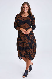 Model Monique wearing size 14 of the Bounce Dress in colour Mocha, from the front, showing the whole outfit