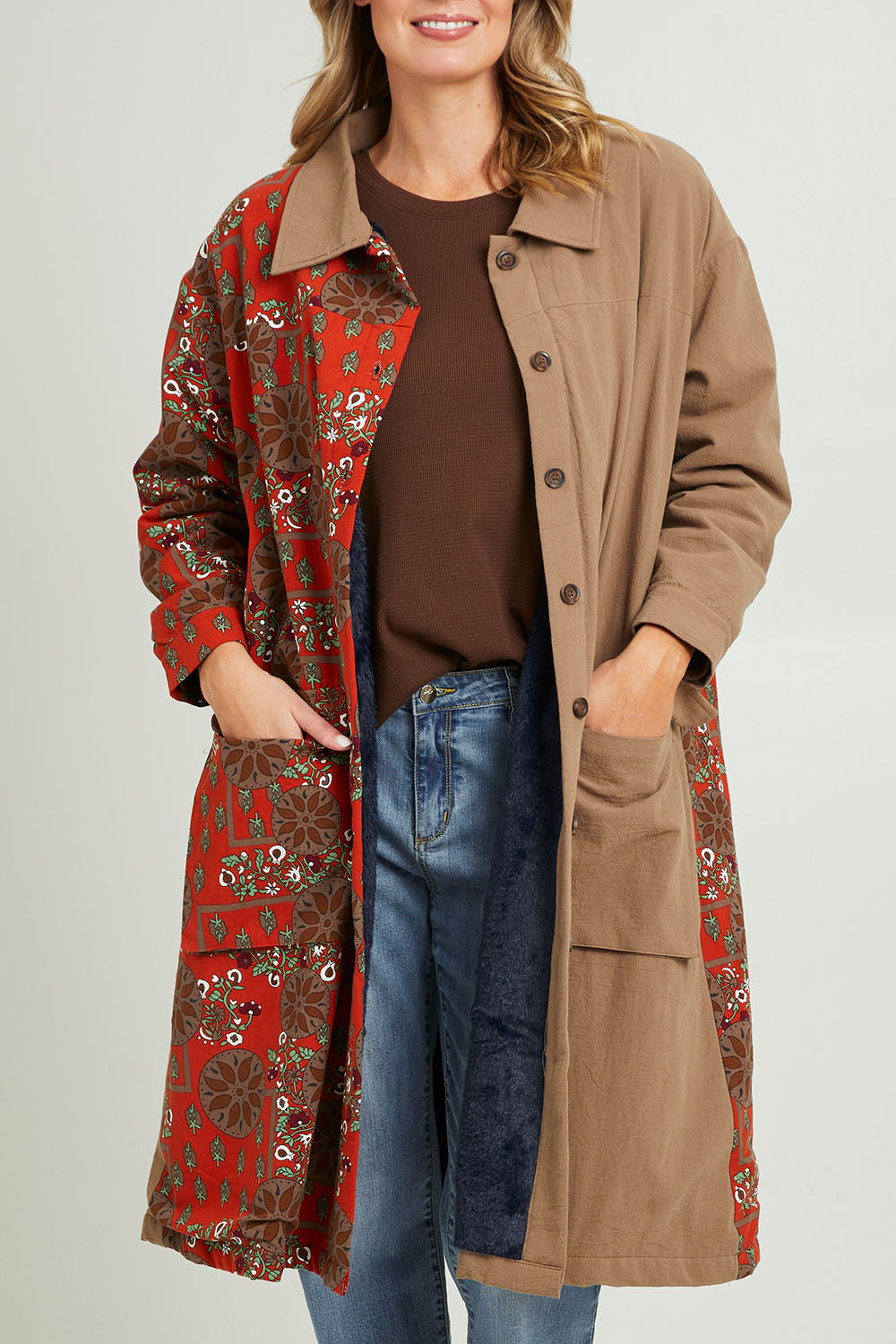 Model Grace wearing size 10 of the Print Splice Coat in colour Rust (Red), from the front, cropped image