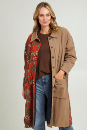 Model Grace wearing size 10 of the Print Splice Coat in colour Rust (Red), from the front, cropped image