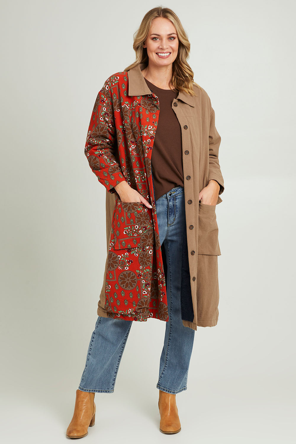 Model Grace wearing size 10 of the Print Splice Coat in colour Rust (Red), from the front, showing the whole outfit