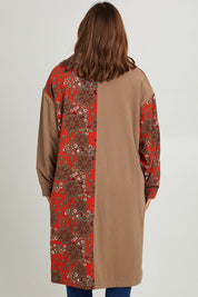 Model Monique wearing size 14 of the Print Splice Coat in colour Rust (Red), from the back