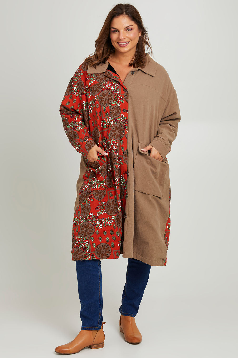 Model Monique wearing size 14 of the Print Splice Coat in colour Rust (Red), from the front, showing the whole outfit