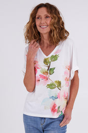 Model Emma wearing size 10 of the Floral Bouquet Tee in colour White (White), from the front, cropped image