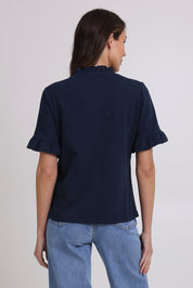 Model Madeline wearing size 10 of the Ruffle Tee Top in colour Navy (Blue), from the back