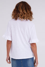 Model Emma wearing size 10 of the Ruffle Tee Top in colour White (White), from the back