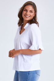 Model Monique wearing size 14 of the Ruffle Tee Top in colour White (White), from the front, cropped image