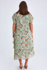 Model Monique wearing size 14 of the Floral Tiers Print Dress in colour Sage (Green), from the back
