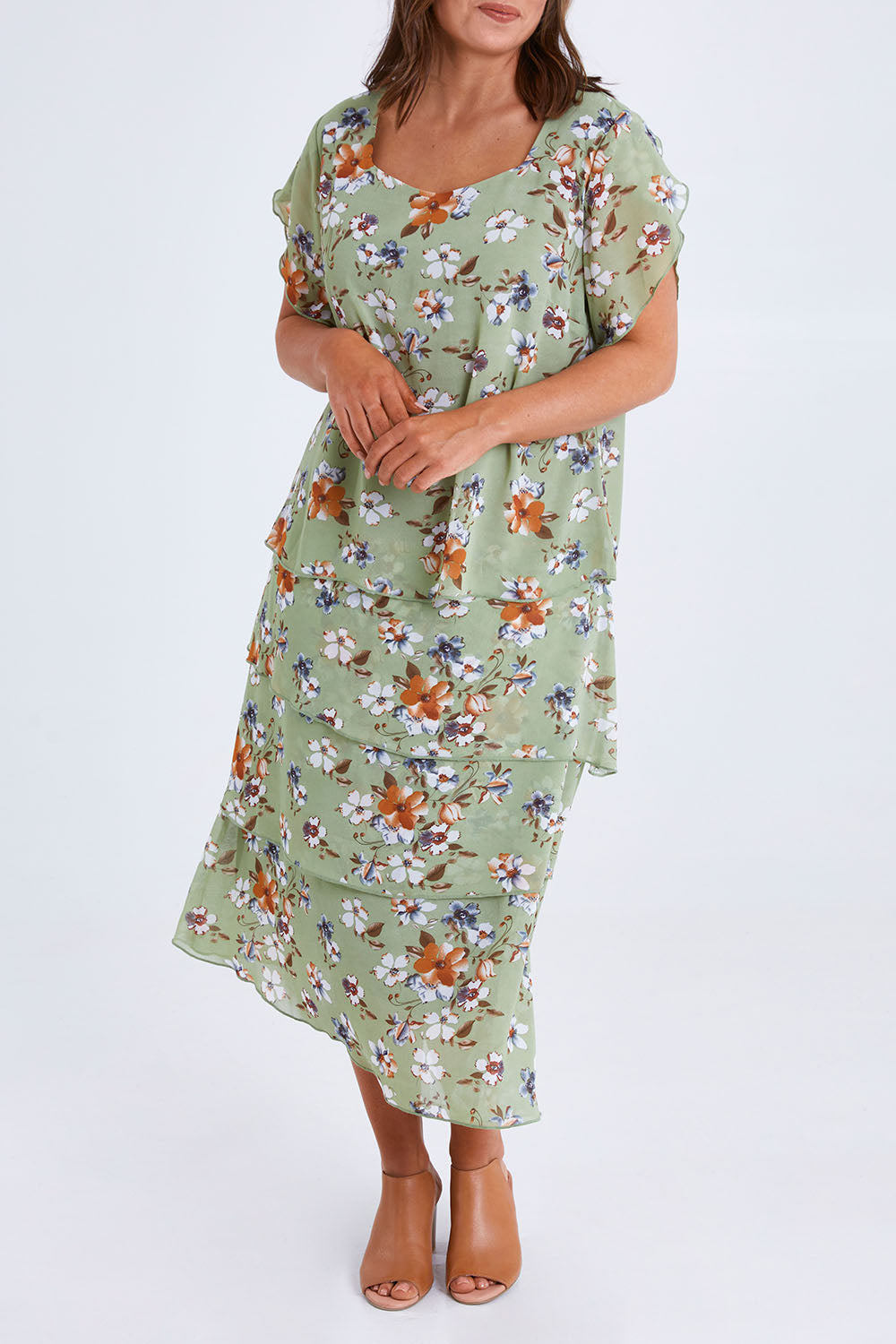 Model Monique wearing size 14 of the Floral Tiers Print Dress in colour Sage (Green), from the front, cropped image