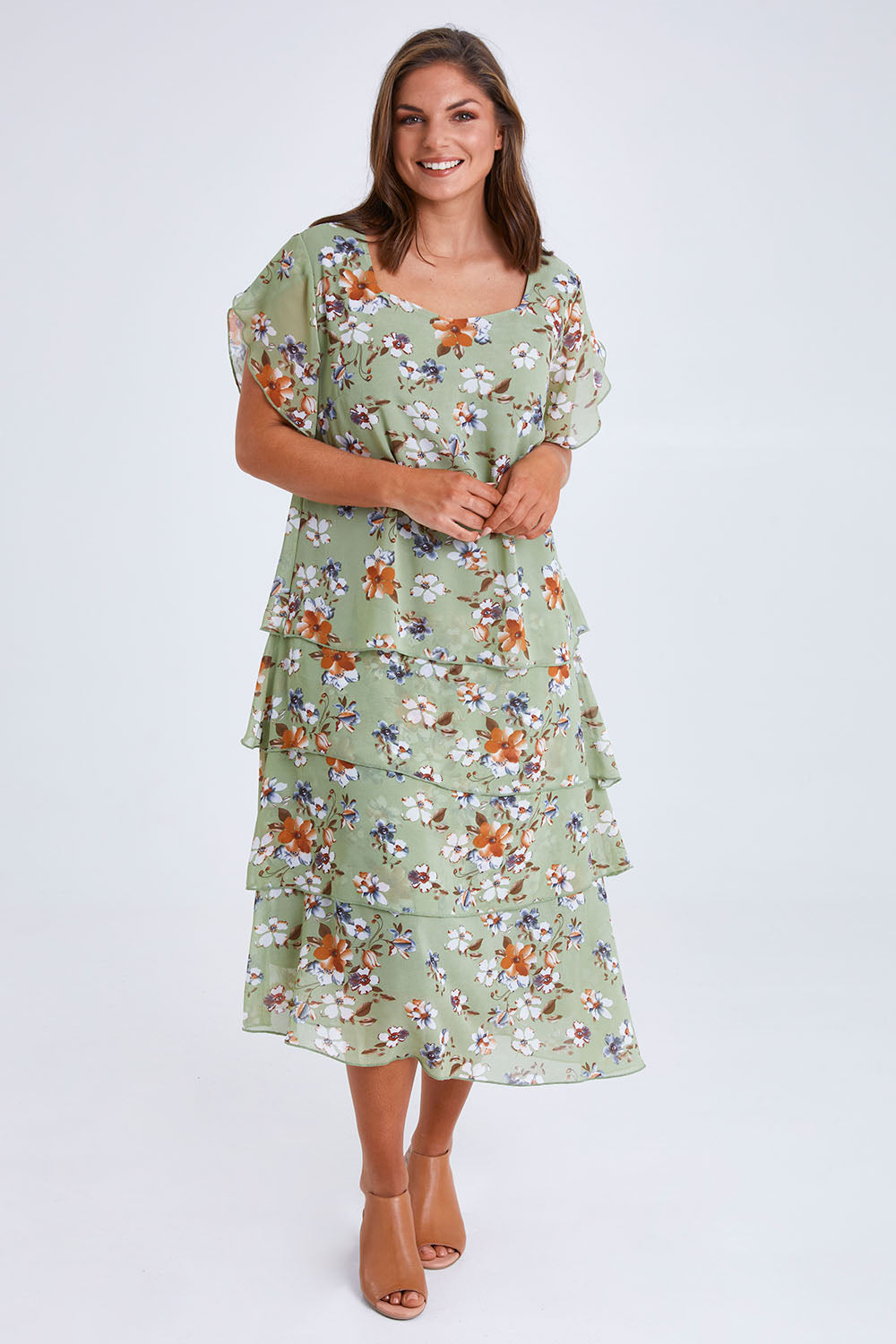 Model Monique wearing size 14 of the Floral Tiers Print Dress in colour Sage (Green), from the front, showing the whole outfit