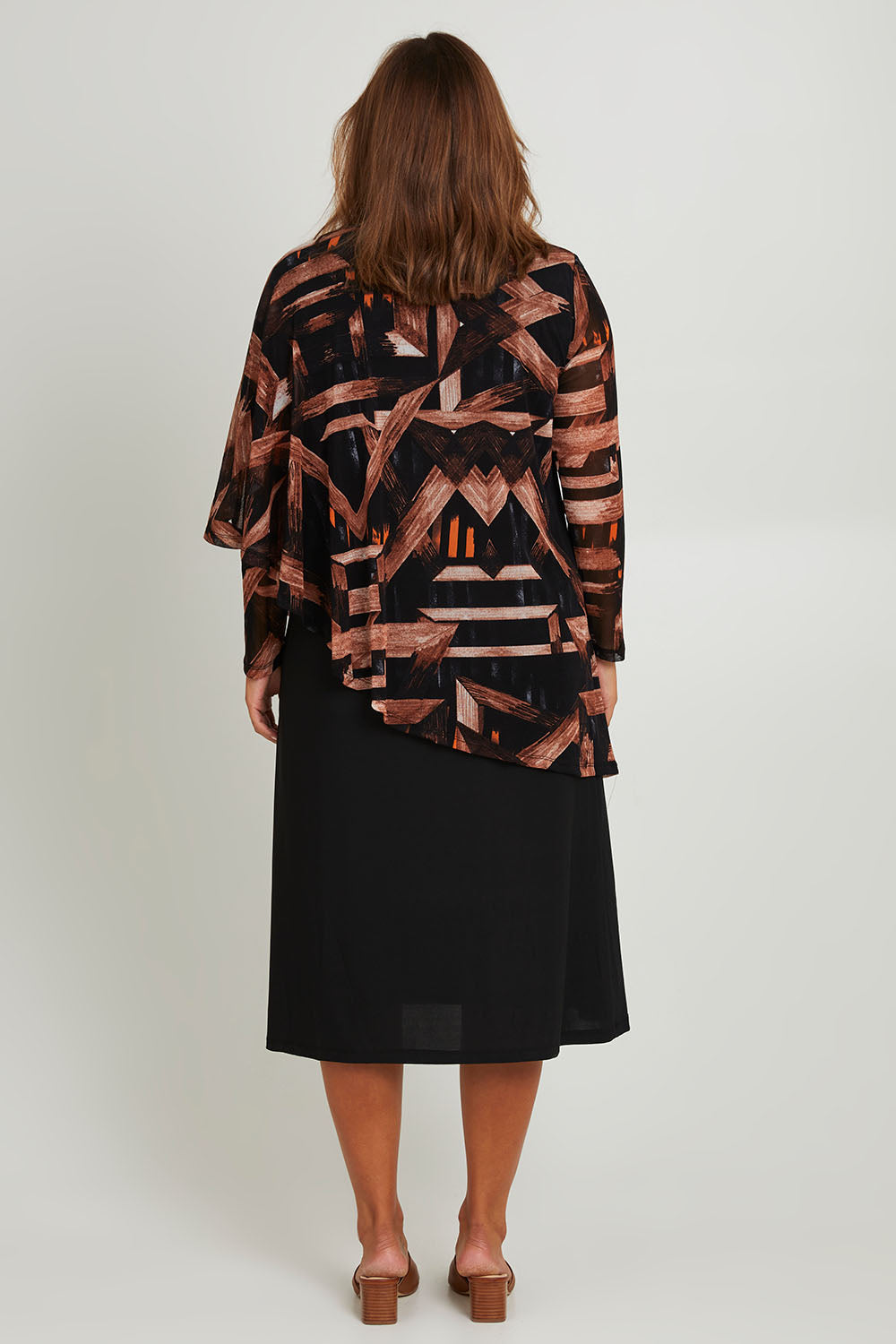 Model Monique wearing size 14 of the Overlay Cap Dress in colour Coffee (Blue), from the back