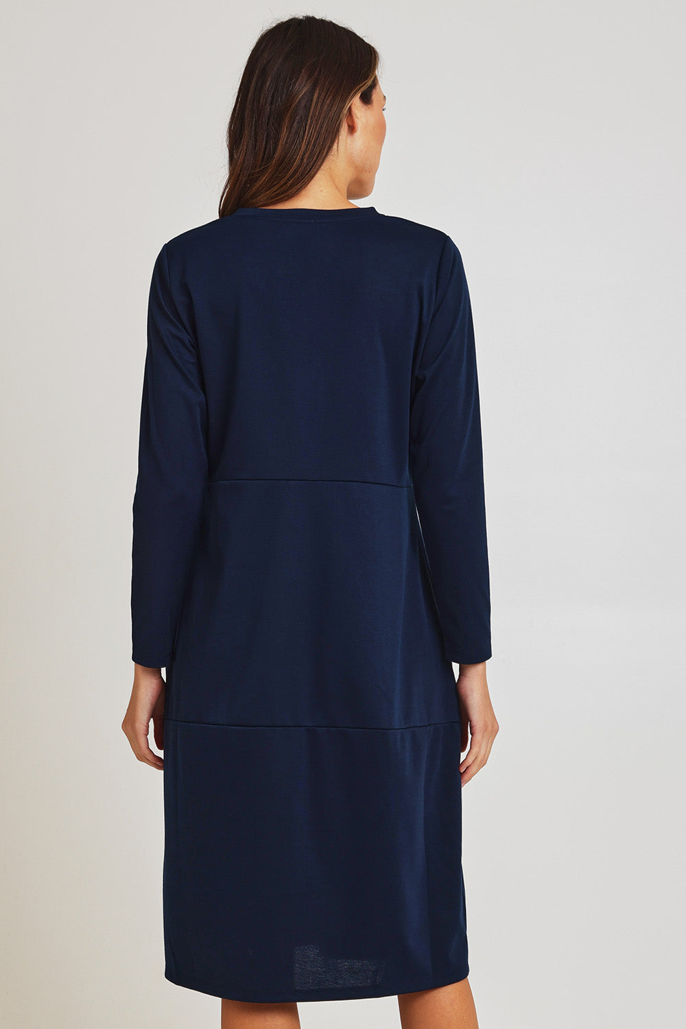 Model Madeline wearing size 10 of the Core Pocket Dress in colour Navy (Blue), from the back