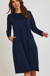 Model Madeline wearing size 10 of the Core Pocket Dress in colour Navy (Blue), from the front, cropped image