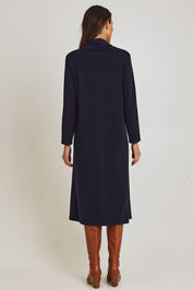Model Madeline wearing size 10 of the Margie Cowl Pocket Cotton Blend Dress in colour Navy (Blue), from the back