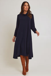 Model Madeline wearing size 10 of the Margie Cowl Pocket Cotton Blend Dress in colour Navy (Blue), from the front, showing the whole outfit