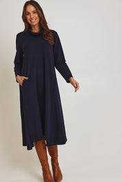 Model Madeline wearing size 10 of the Margie Cowl Pocket Cotton Blend Dress in colour Navy (Blue), from the front, showing the whole outfit