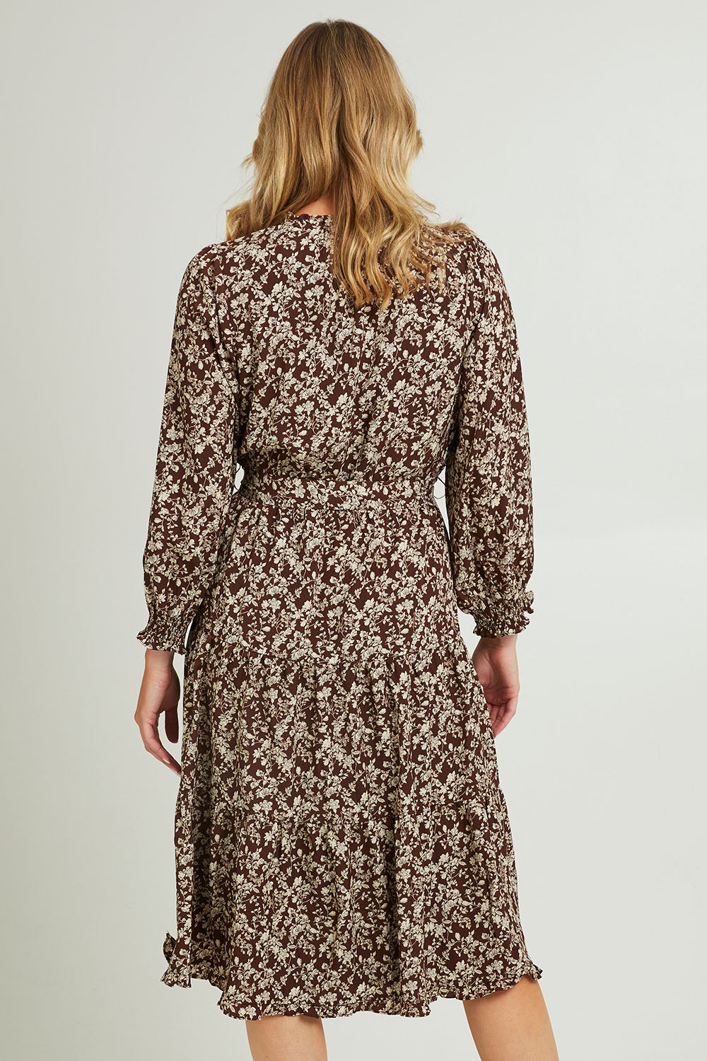 Model Grace wearing size 10 of the Felicia Dress in colour Mocha, from the back