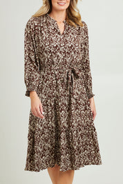 Model Grace wearing size 10 of the Felicia Dress in colour Mocha, from the front, cropped image