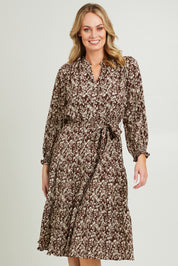 Model Grace wearing size 10 of the Felicia Dress in colour Mocha, from the front, cropped image