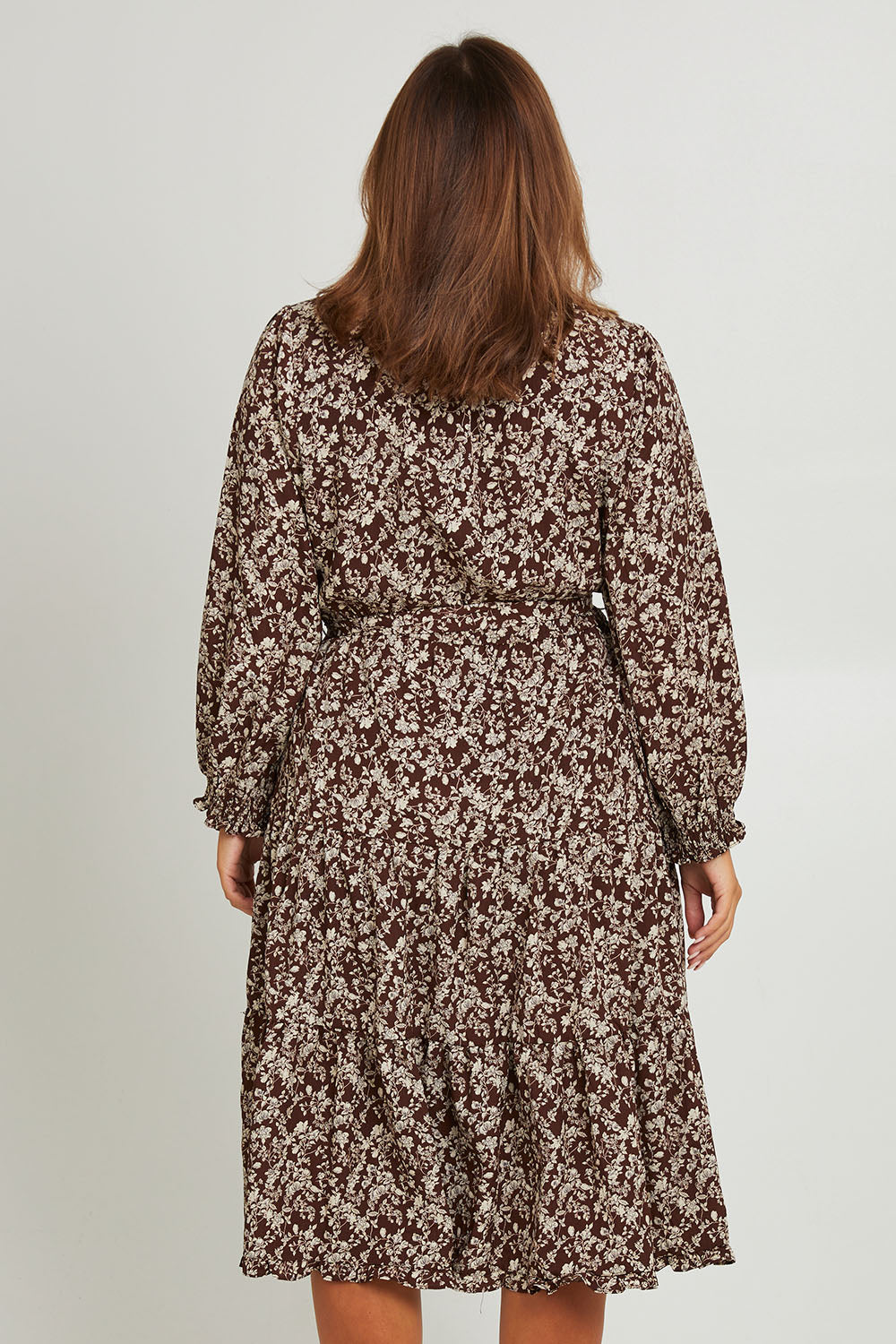 Model Monique wearing size 14 of the Felicia Dress in colour Mocha, from the back
