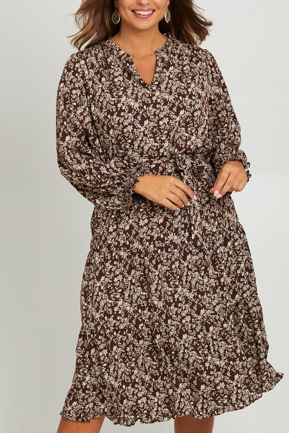 Model Monique wearing size 14 of the Felicia Dress in colour Mocha, from the front, cropped image