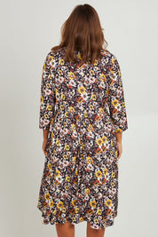 Model Monique wearing size 14 of the Jessie L/S Dress in colour Black (Black), from the back