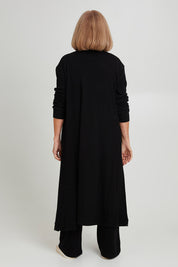 Model Sandy wearing size 10 of the Rachel Rib Duster in colour Black (Black), from the back