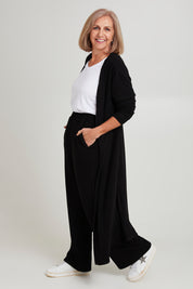 Model Sandy wearing size 10 of the Rachel Rib Duster in colour Black (Black), from the front, showing the whole outfit