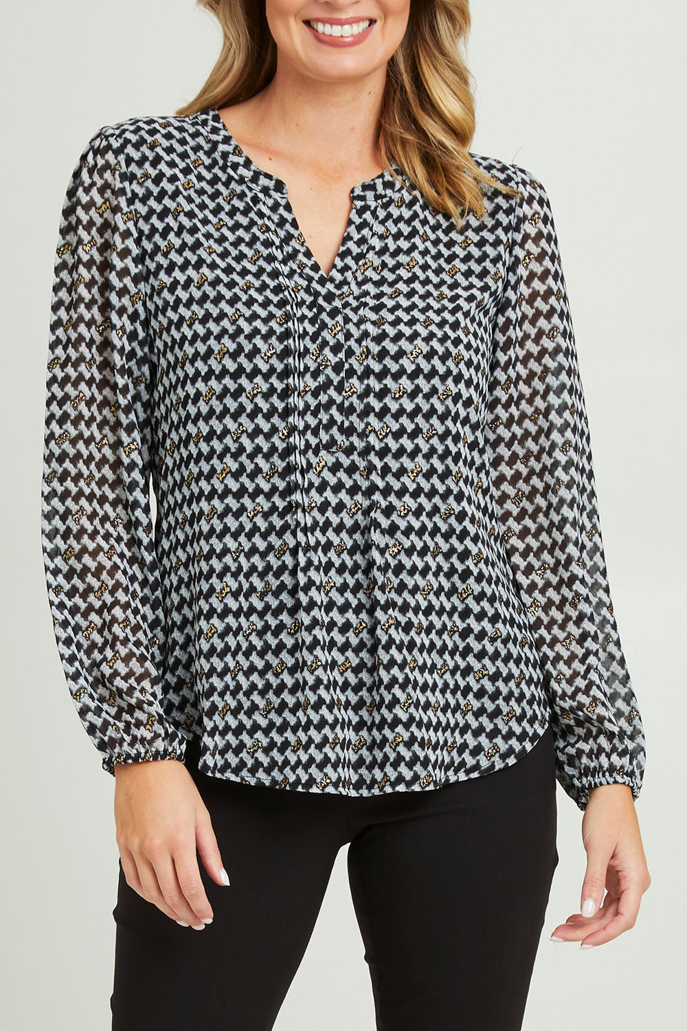Model Grace wearing size 10 of the Chiffon Pintuck Top in colour Check (Black), from the front, cropped image