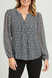 Model Grace wearing size 10 of the Chiffon Pintuck Top in colour Check (Black), from the front, cropped image