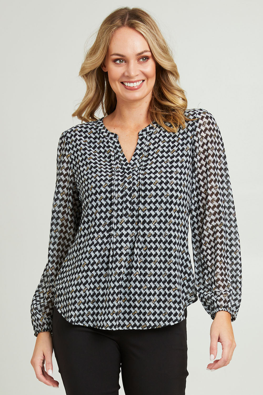 Model Grace wearing size 10 of the Chiffon Pintuck Top in colour Check (Black), from the front, cropped image