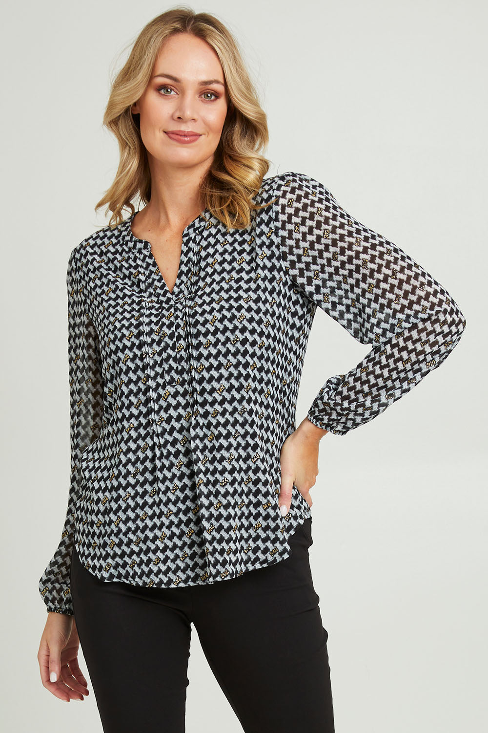 Model Grace wearing size 10 of the Chiffon Pintuck Top in colour Check (Black), from the front, cropped image