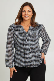 Model Monique wearing size 14 of the Chiffon Pintuck Top in colour Check (Black), from the front, cropped image