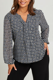 Model Monique wearing size 14 of the Chiffon Pintuck Top in colour Check (Black), from the front, cropped image