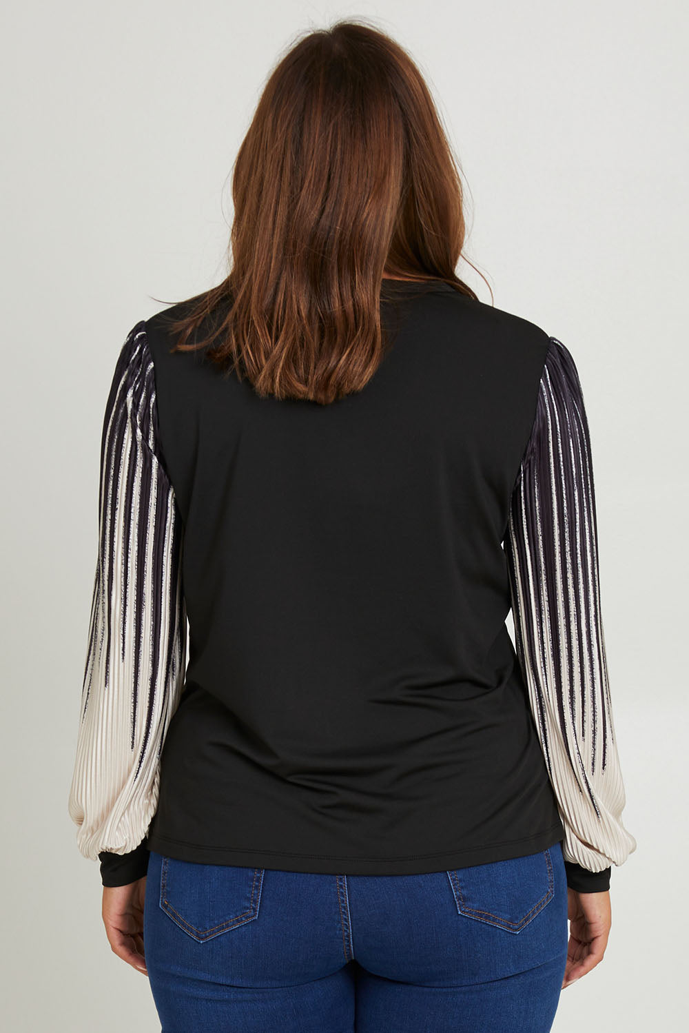 Model Monique wearing size 14 of the Contrast Pleat Top in colour Black (Black), from the back