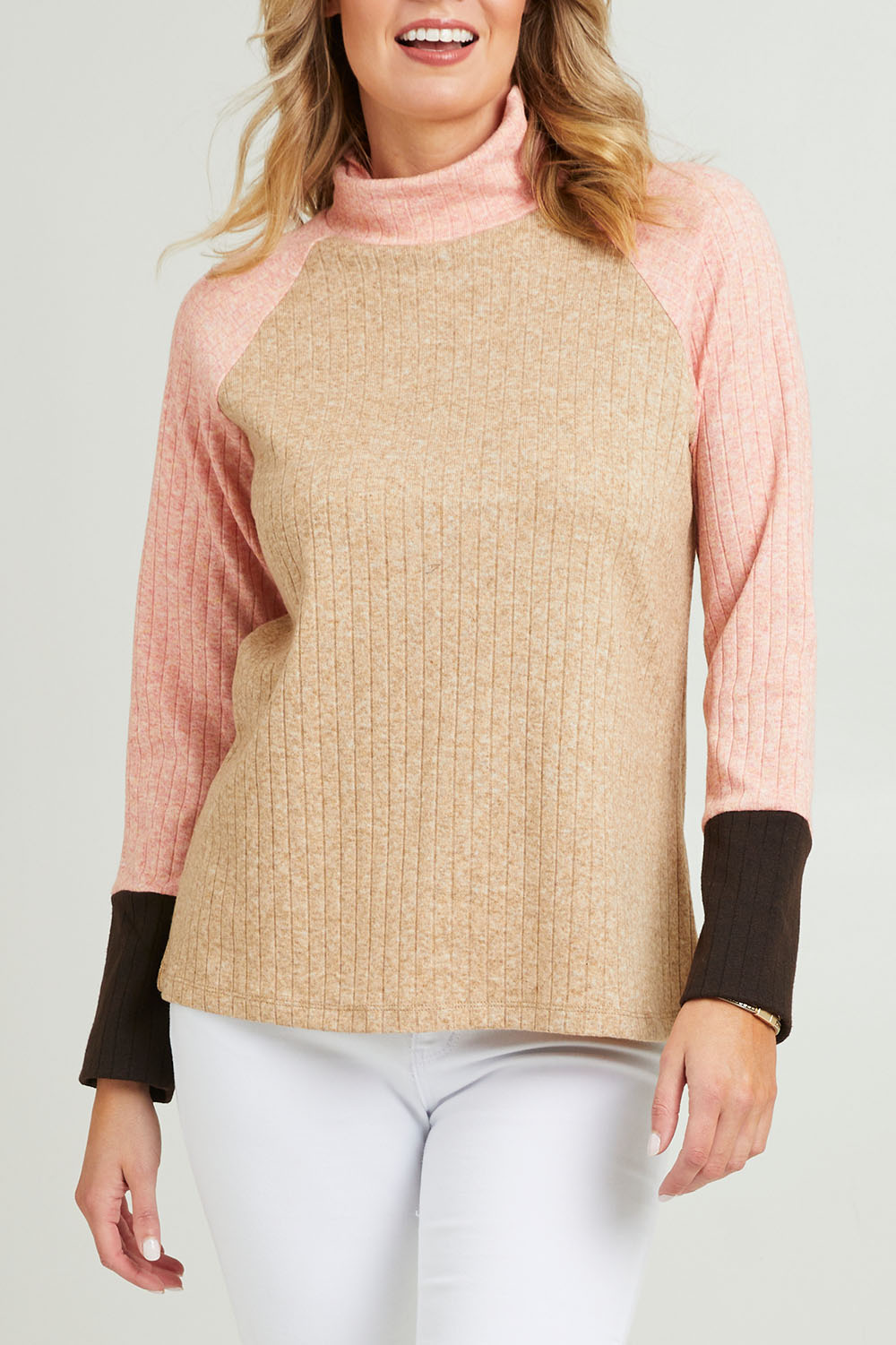 Model Grace wearing size 10 of the Spliced Cowl Rib Top in colour Coral, from the front, cropped image