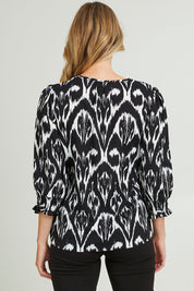 Model Grace wearing size 10 of the Felicia Top in colour Aztec (Blue), from the back