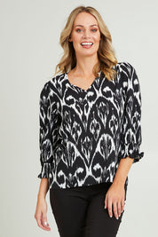 Model Grace wearing size 10 of the Felicia Top in colour Aztec (Blue), from the front, cropped image