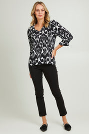Model Grace wearing size 10 of the Felicia Top in colour Aztec (Blue), from the front, showing the whole outfit